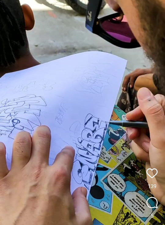 k shares preparing graffiti art on paper at pahari goat festival